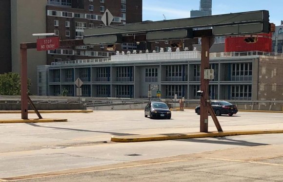 Ban Parking on Roosevelt Island Main Street? Stanchion still standing where RIOC booths controlling Roosevelt Island access for cars once stood. Note the "No Entry" sign left behind.